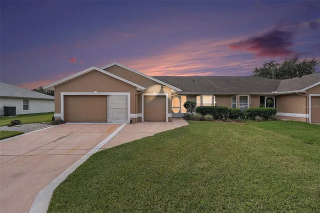 a front view of a house with a garden and yard