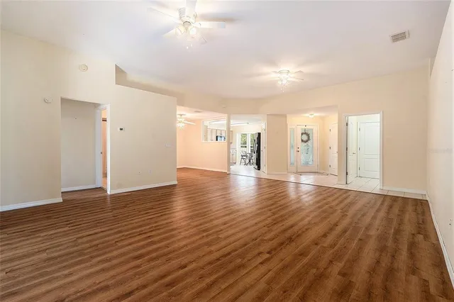 a view of a livingroom with wooden floor and staircase