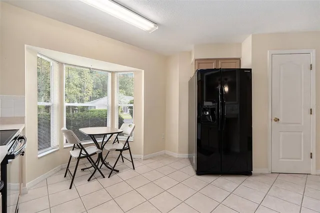 a view of a dining room with furniture and a window