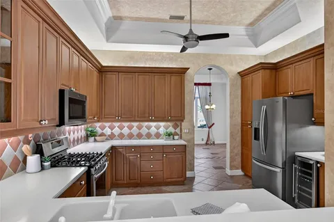 an empty room with windows and ceiling fan