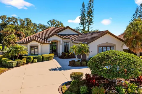 a front view of a house with a yard and potted plants
