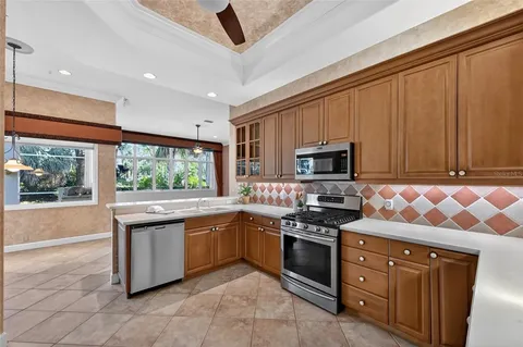 a kitchen with stainless steel appliances granite countertop a refrigerator and a stove