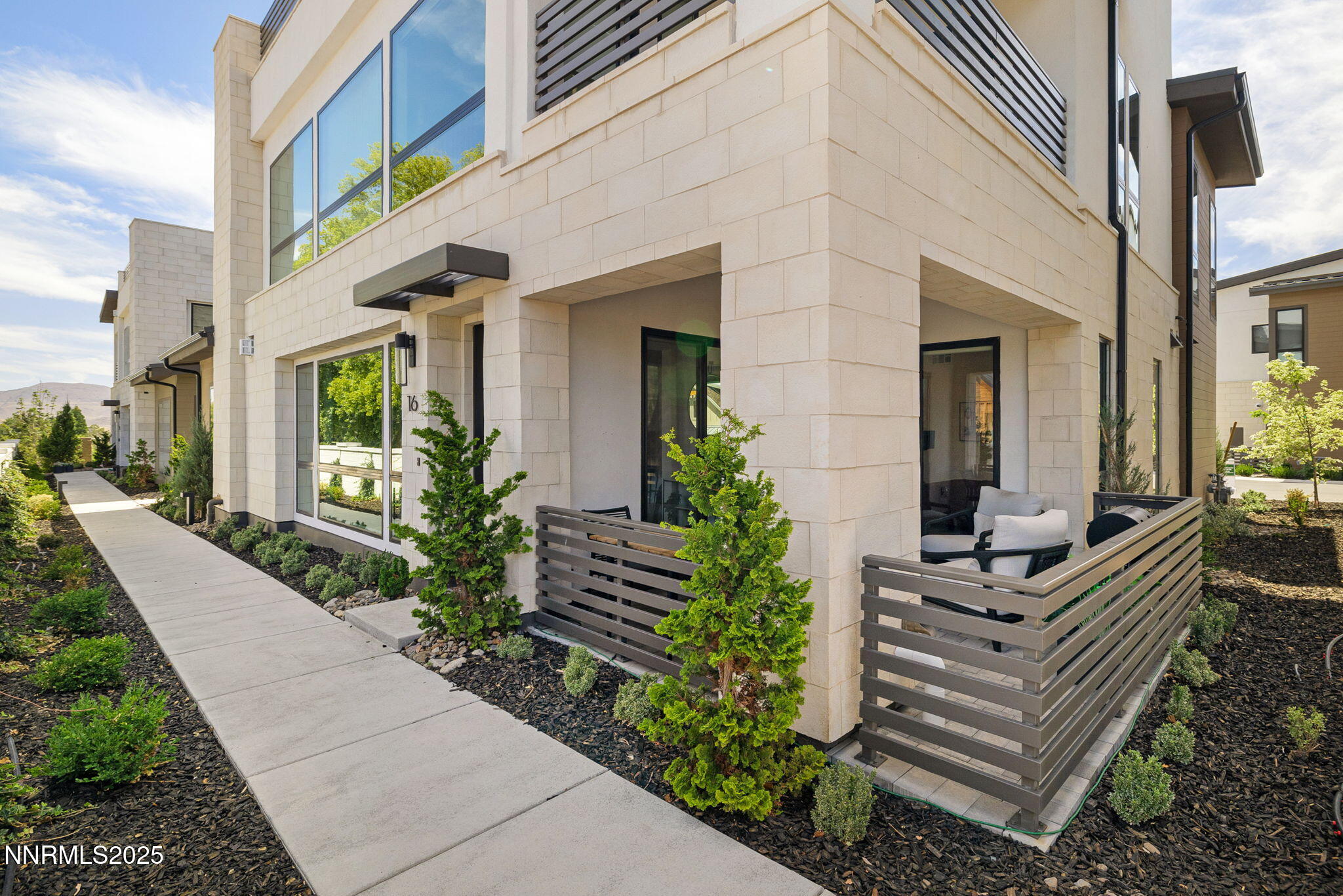 a view of a house with stairs and plants