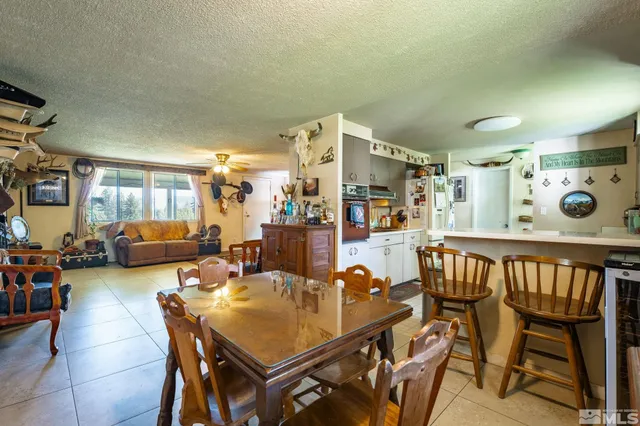 a view of a dining room with furniture and a potted plant