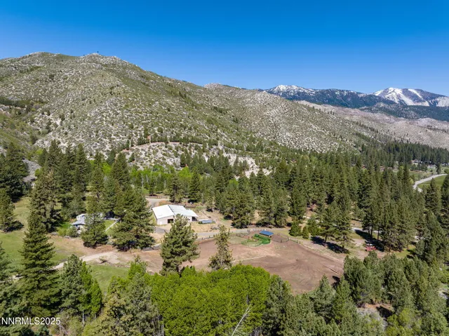 a view of a yard with mountains in the background
