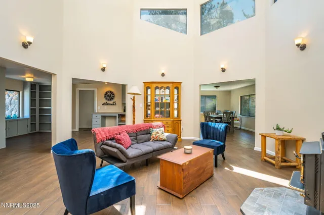 a living room with furniture wooden floor and a large window