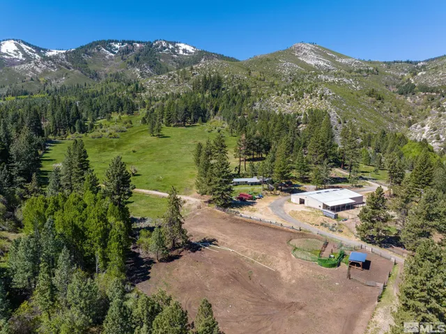 an aerial view of a house with mountain view