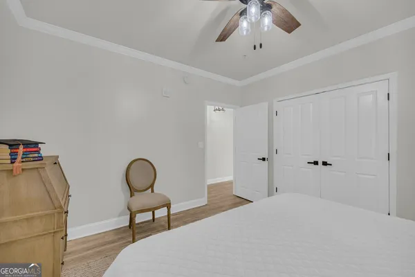 a bedroom with a bed and a chandelier