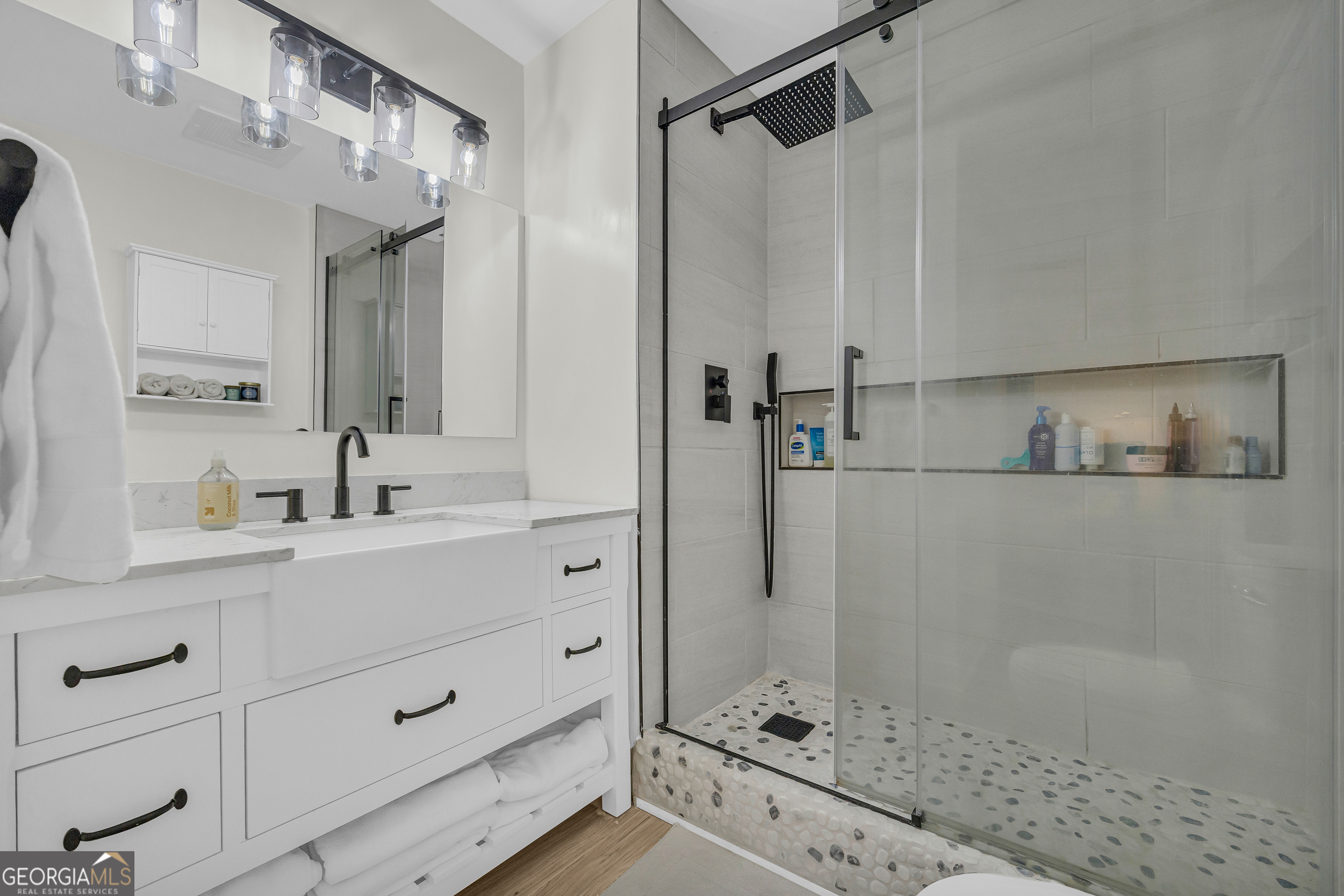 755 East Broad Street, Unit 803 Athens, GA 30601 - Photo 22 of 57 a bathroom with a shower sink and mirror