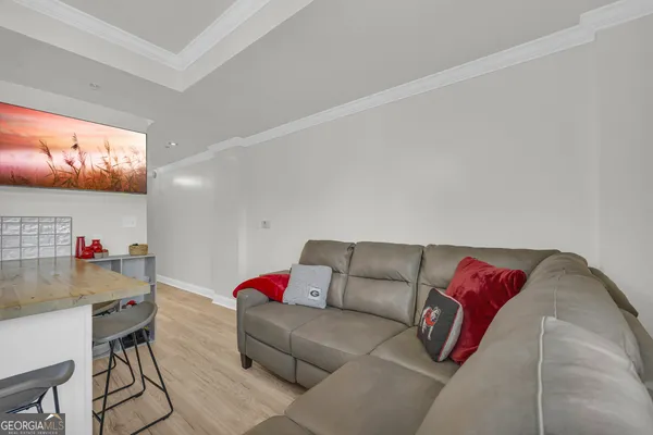 a view of a dining room with furniture and a chandelier
