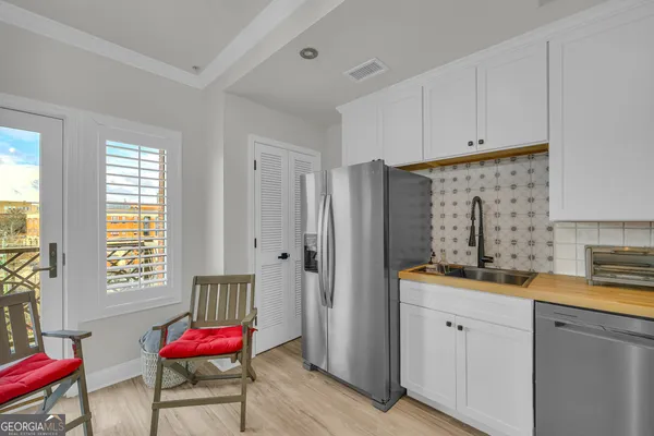 a kitchen with stainless steel appliances a refrigerator sink and cabinets