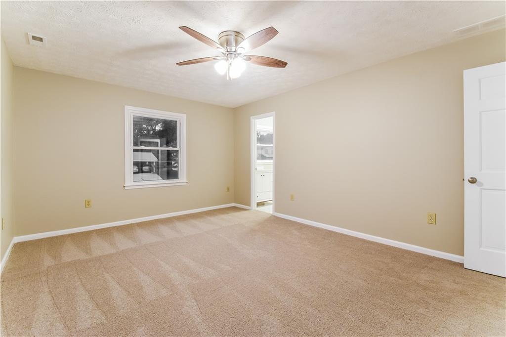 3119 Windfield Circle Tucker, GA 30084 - Photo 11 of 20 an empty room with windows and ceiling fan