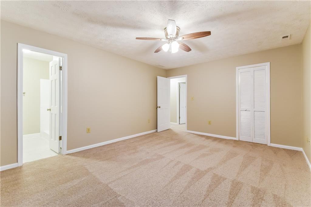3119 Windfield Circle Tucker, GA 30084 - Photo 12 of 20 a view of an empty room with a chandelier fan