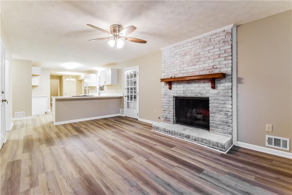 3119 Windfield Circle Tucker, GA 30084 - Photo 5 of 20 a view of a livingroom with a fireplace a ceiling fan and wooden floor