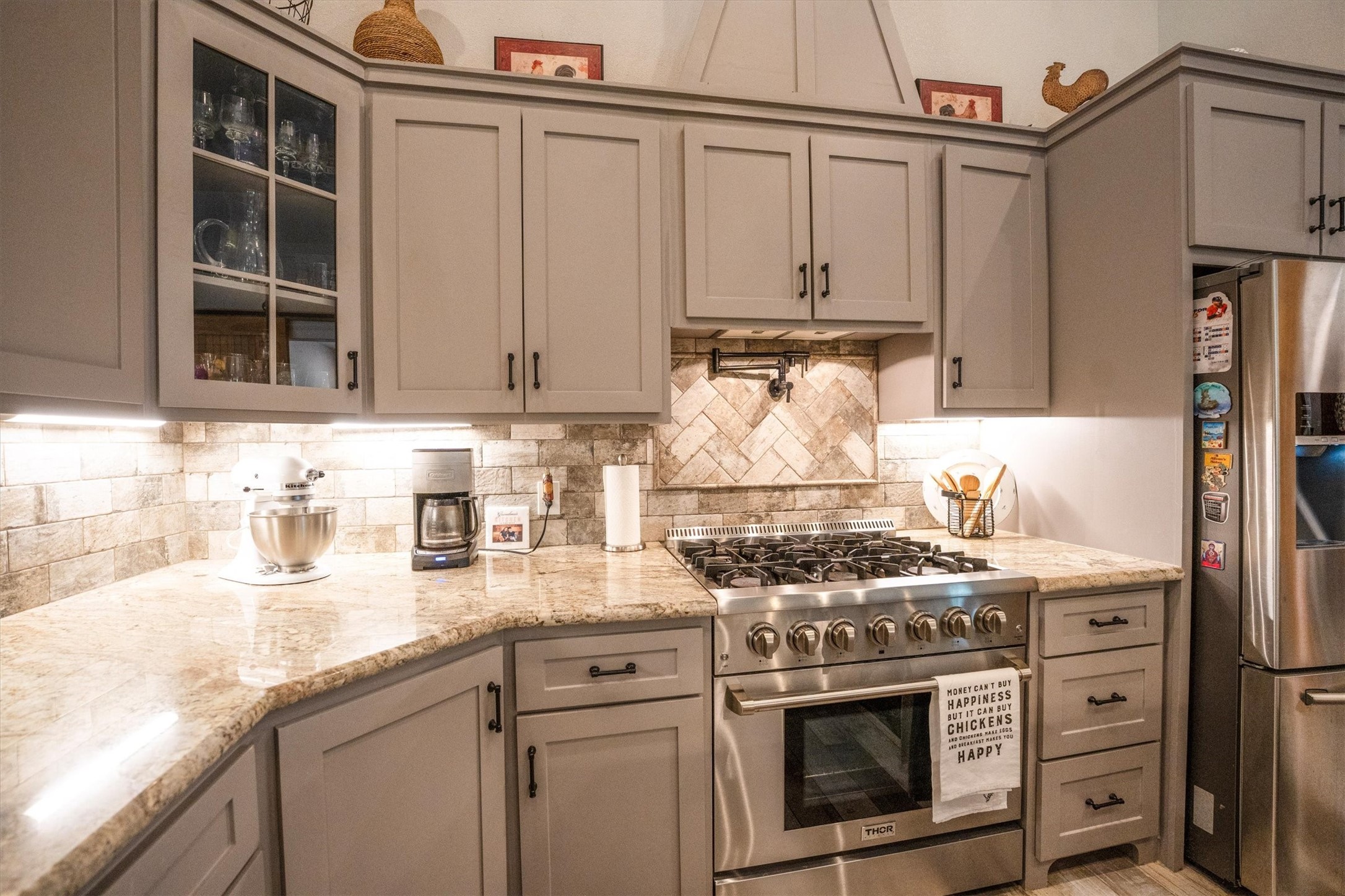 1022 Fm 1696 Road West Huntsville, TX 77320 - Photo 15 of 50 A gas stove with pot filler and beautiful custom cabinetry