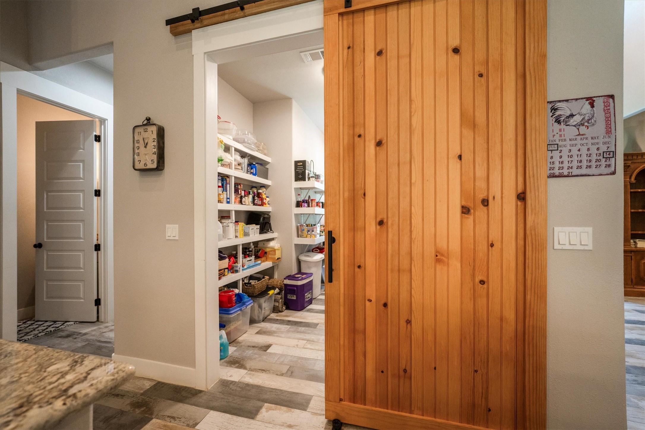 1022 Fm 1696 Road West Huntsville, TX 77320 - Photo 19 of 50 A barn door opens to an extra large storage pantry