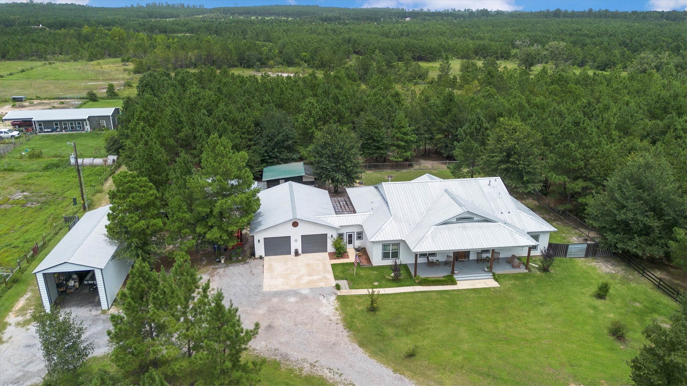 1022 Fm 1696 Road West Huntsville, TX 77320 - Photo 3 of 50 Aerial view showing the home with breezeway connecting the 2 car garage, and RV storage to the left