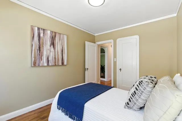 a bedroom with a bed and a painting on the wall