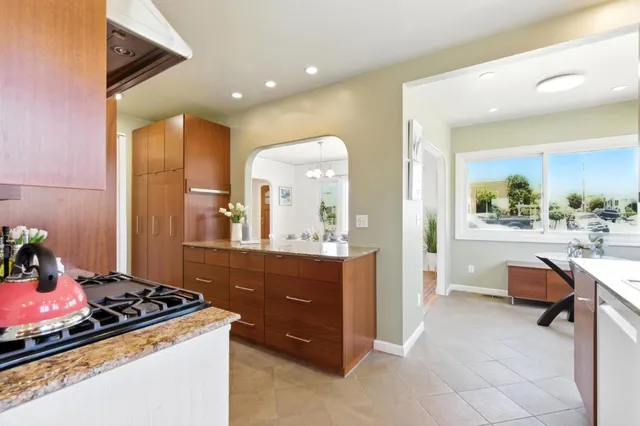 a kitchen with stainless steel appliances granite countertop a stove and a refrigerator