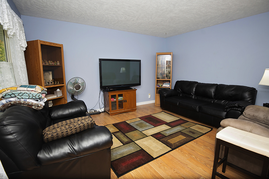 1313 Rutledge Road Bloomington, IL 61704 - Photo 4 of 29 a living room with furniture and a flat screen tv