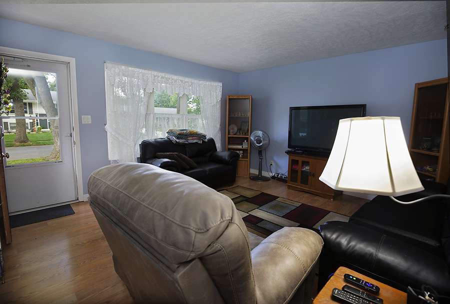 1313 Rutledge Road Bloomington, IL 61704 - Photo 5 of 29 a living room with furniture and a flat screen tv