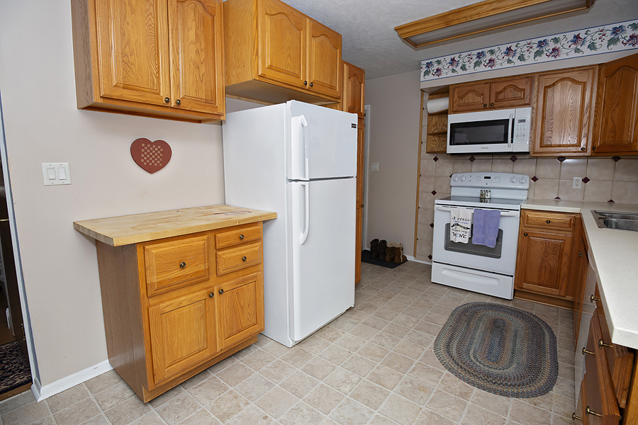 1313 Rutledge Road Bloomington, IL 61704 - Photo 8 of 29 a kitchen with stainless steel appliances granite countertop a refrigerator and a stove top oven