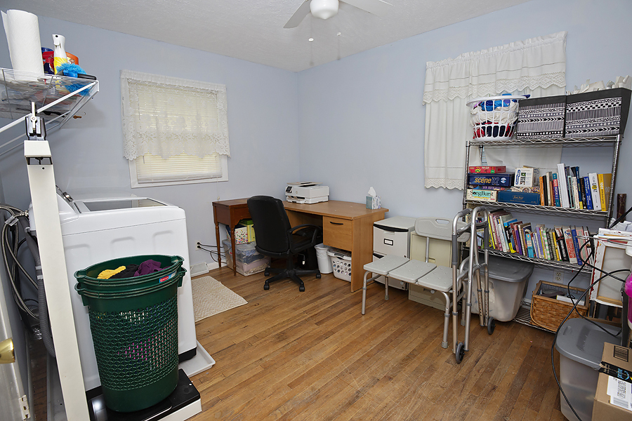 1313 Rutledge Road Bloomington, IL 61704 - Photo 10 of 29 a view of a workspace with furniture and a book shelf