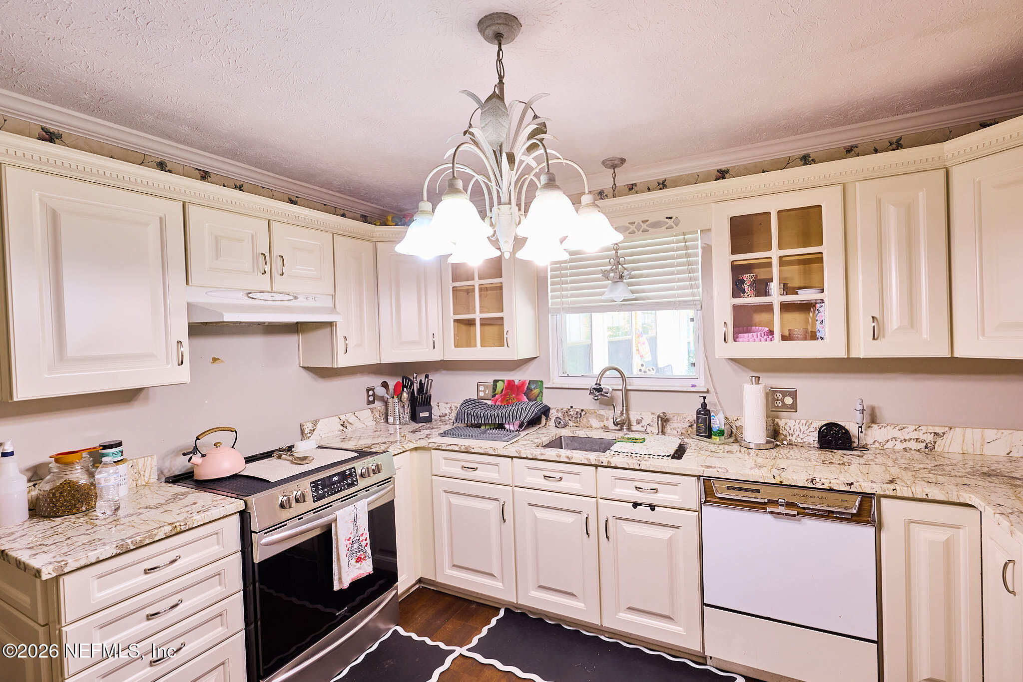 8965 San Rae Road Jacksonville, FL 32257 - Photo 27 of 46 a kitchen with stainless steel appliances granite countertop a stove a sink dishwasher and white cabinets with wooden floor