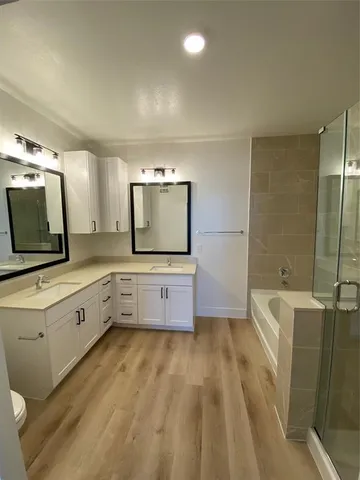 a kitchen with granite countertop a sink and a flat screen tv