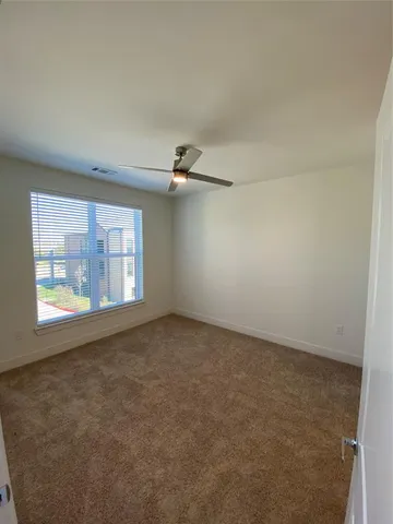 an empty room with windows and entrance