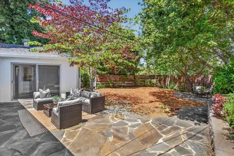 a outdoor space with patio the couches and a fireplace