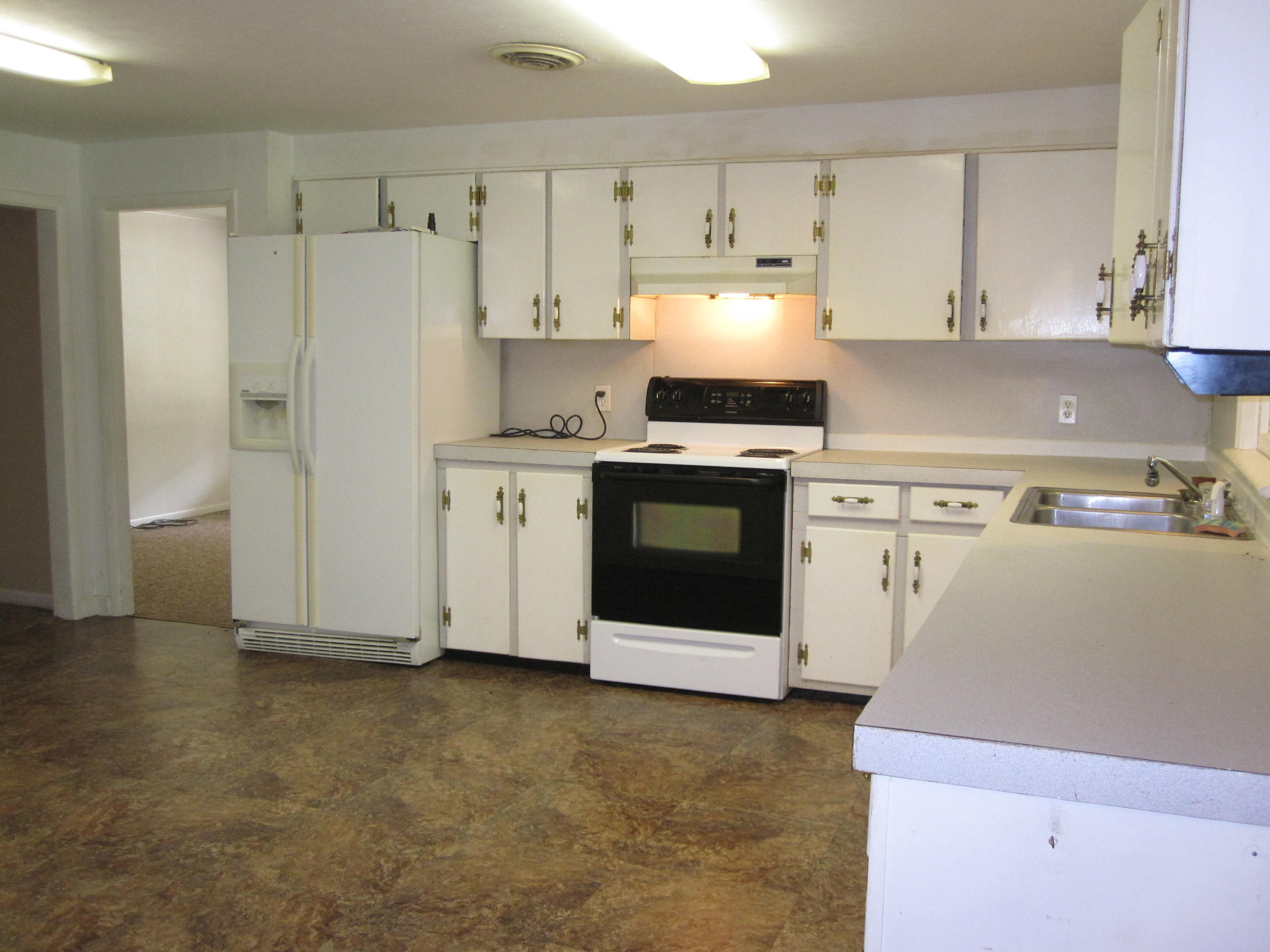 5260 Old River Road Baker, FL 32531 - Photo 5 of 30 a kitchen with cabinets and white stainless steel appliances