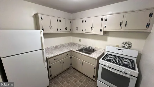 a kitchen with a stove and white cabinets