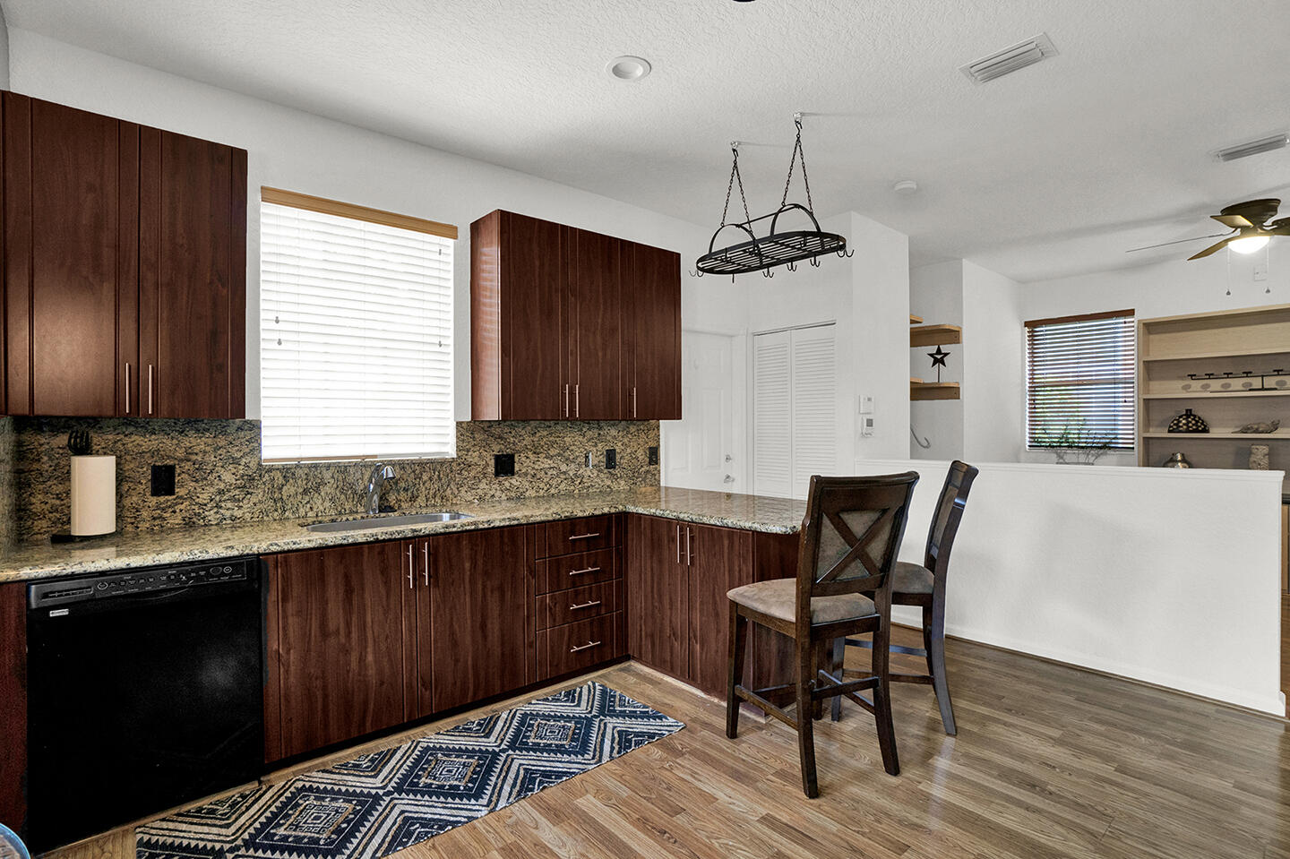 22831 Windsor Wood Court Boca Raton, FL 33433 - Photo 8 of 48 a kitchen with granite countertop wooden floors cabinets a dining table and chairs