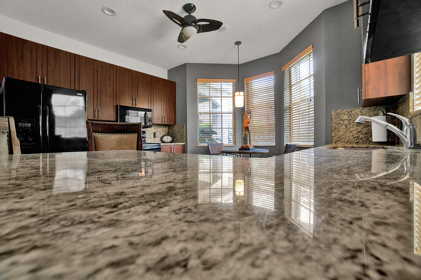 22831 Windsor Wood Court Boca Raton, FL 33433 - Photo 10 of 48 a kitchen with granite countertop a stove a sink and a microwave