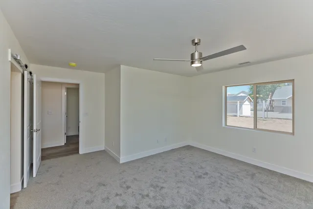 an empty room with a ceiling fan