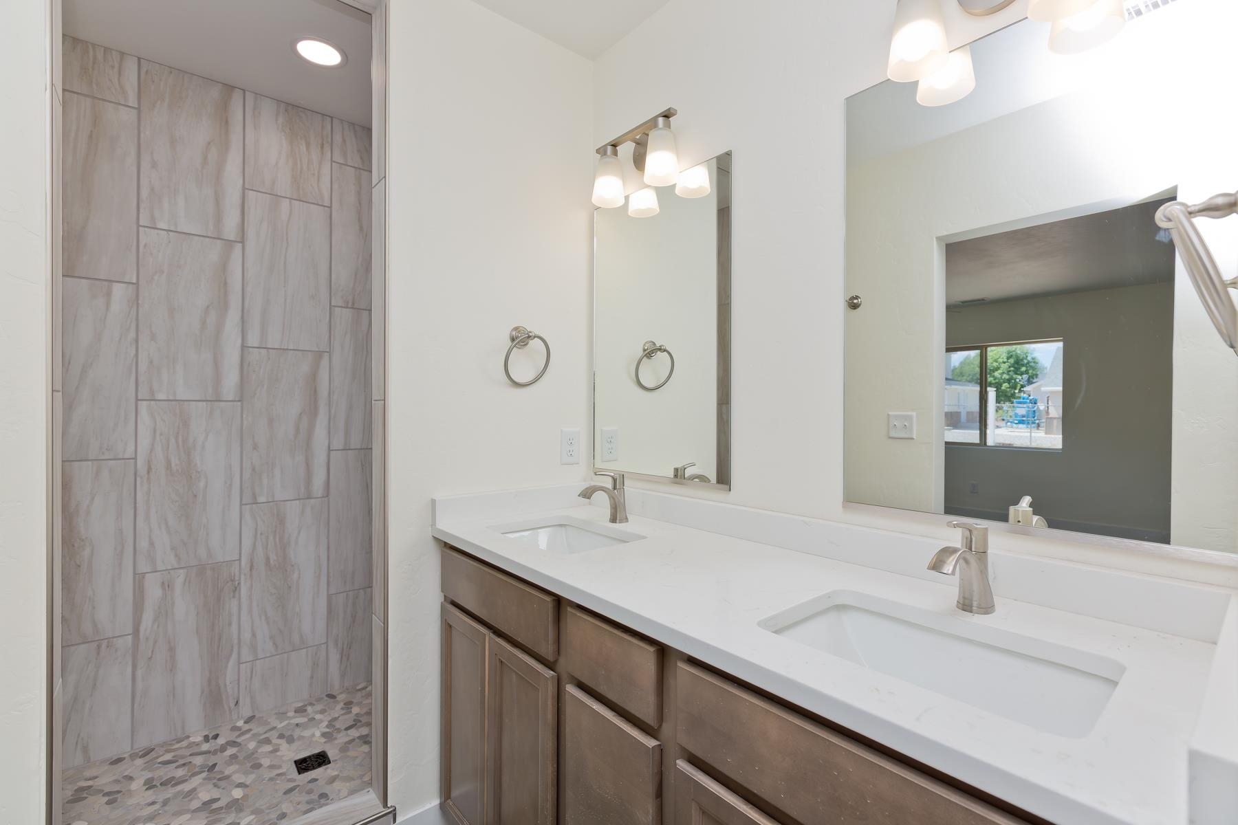 660 Nuvue Street Delta, CO 81416 - Photo 18 of 35 a bathroom with a double vanity sink and a mirror