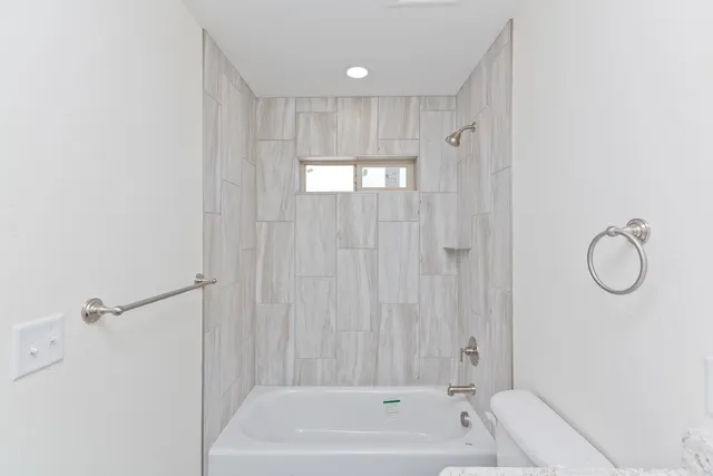 a bathroom with a granite countertop sink a mirror and a shower