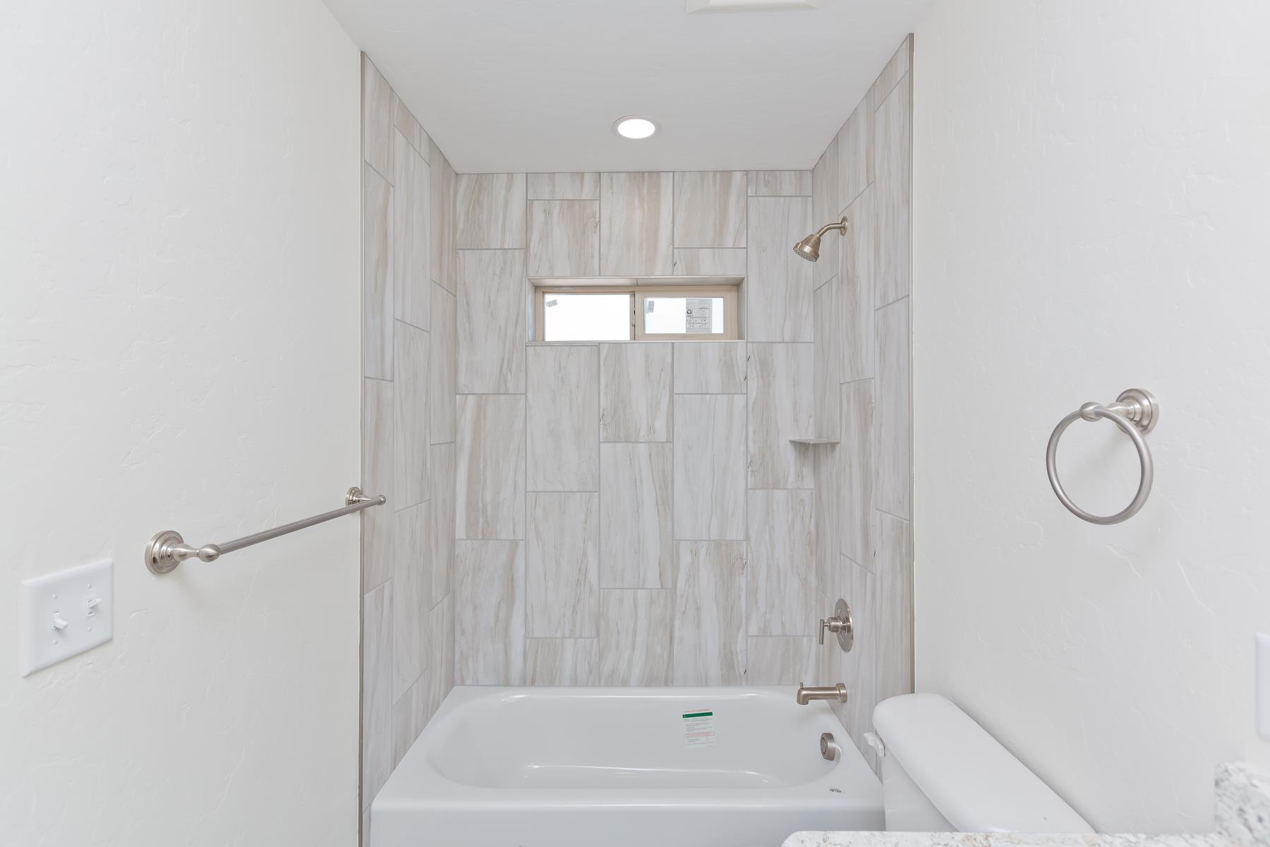 660 Nuvue Street Delta, CO 81416 - Photo 27 of 35 a bathroom with a shower and a tub