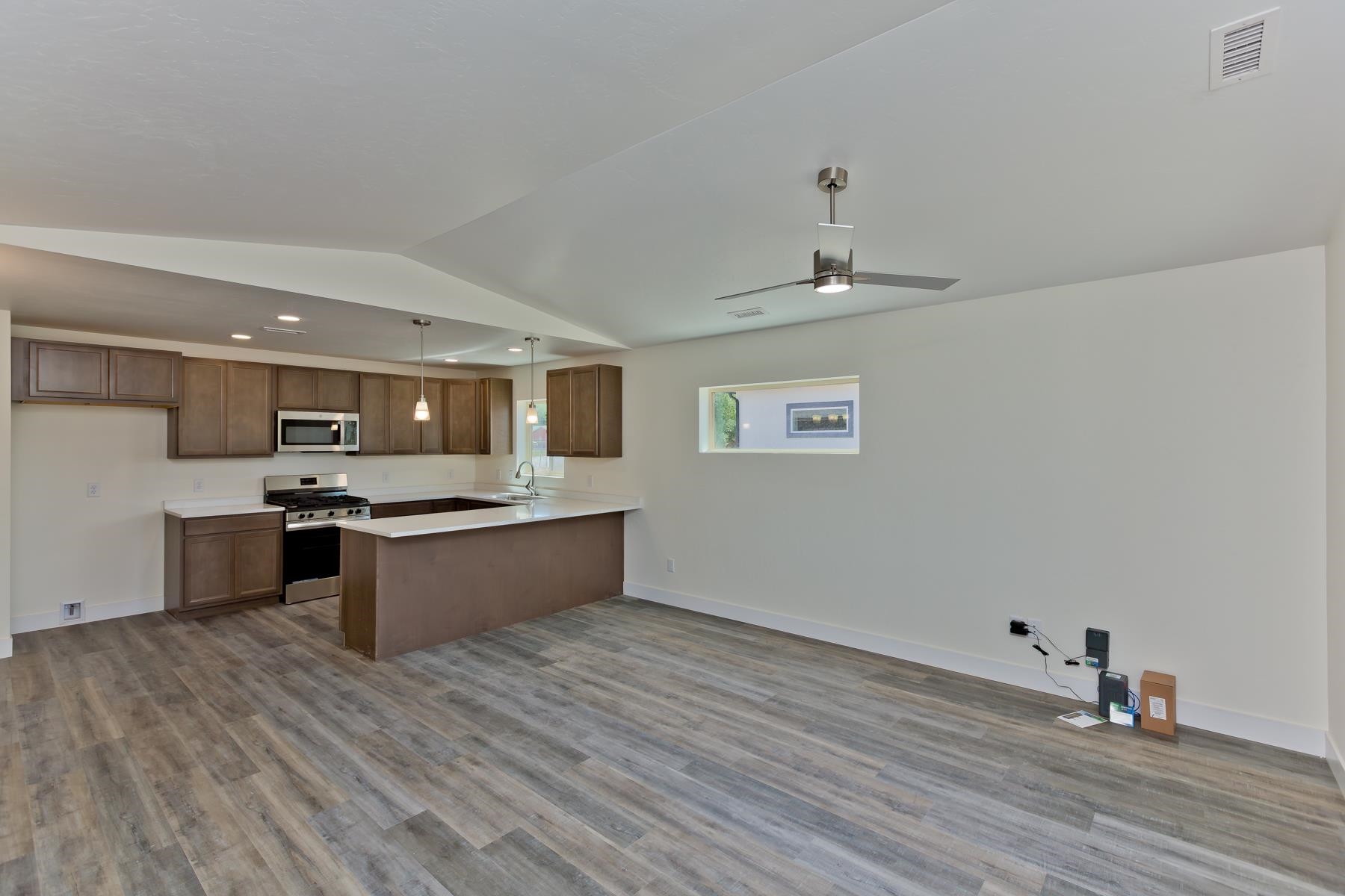 660 Nuvue Street Delta, CO 81416 - Photo 3 of 35 a large kitchen with a wooden floor and stainless steel appliances