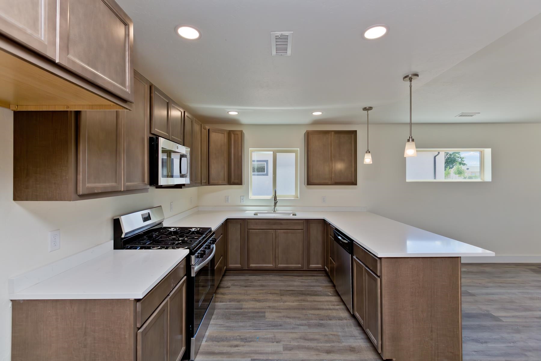 660 Nuvue Street Delta, CO 81416 - Photo 7 of 35 a kitchen with stainless steel appliances a sink stove and cabinets