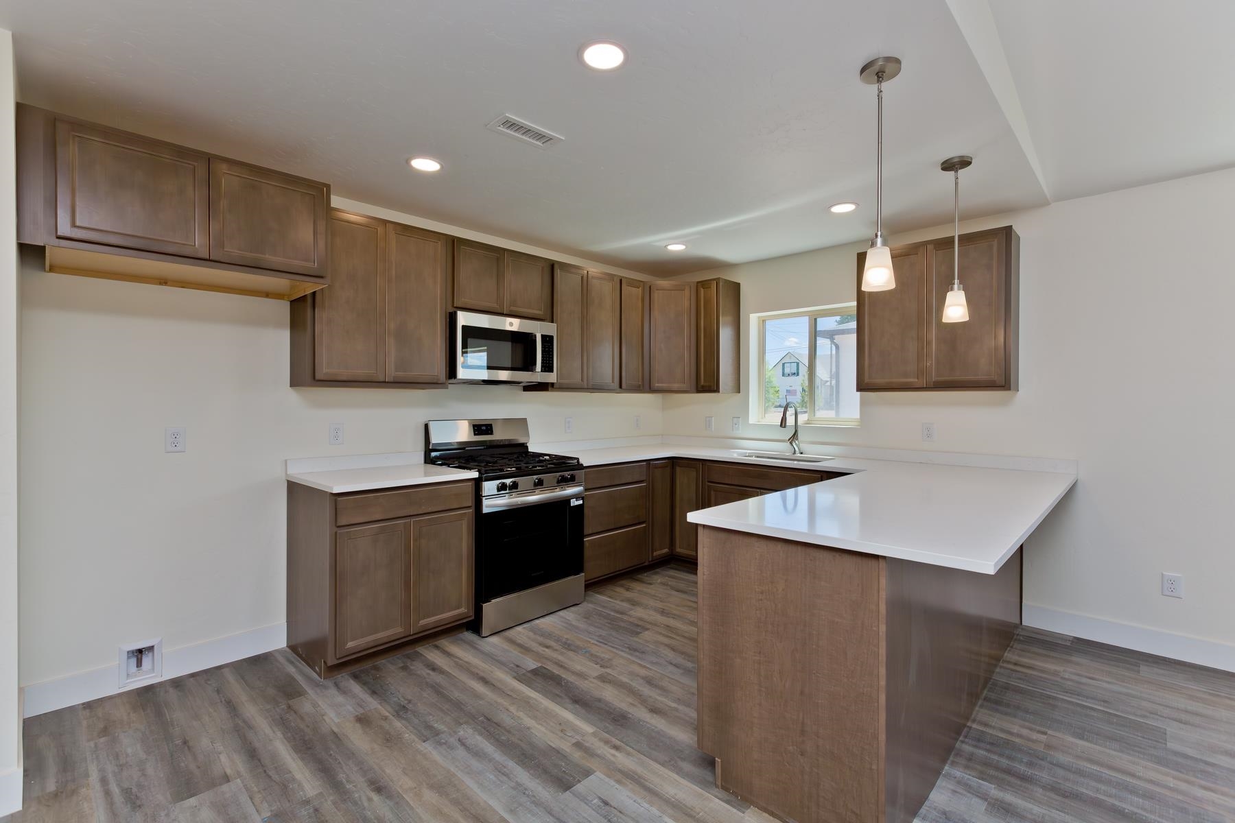 660 Nuvue Street Delta, CO 81416 - Photo 8 of 35 a kitchen with stainless steel appliances granite countertop a sink stove and refrigerator