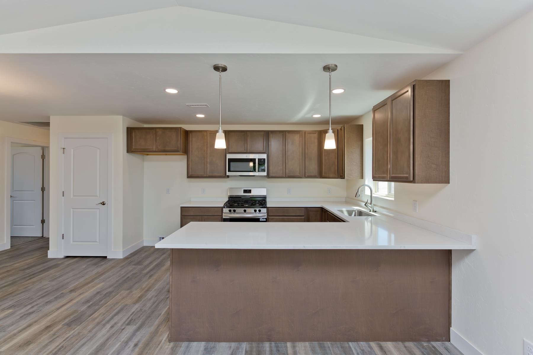 660 Nuvue Street Delta, CO 81416 - Photo 9 of 35 a large white kitchen with a sink and dishwasher