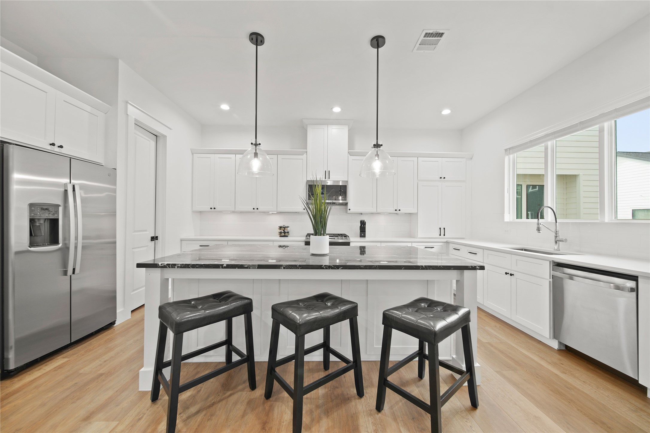 2510 Gray Street Houston, TX 77003 - Photo 10 of 15 a kitchen with granite countertop white cabinets and stainless steel appliances