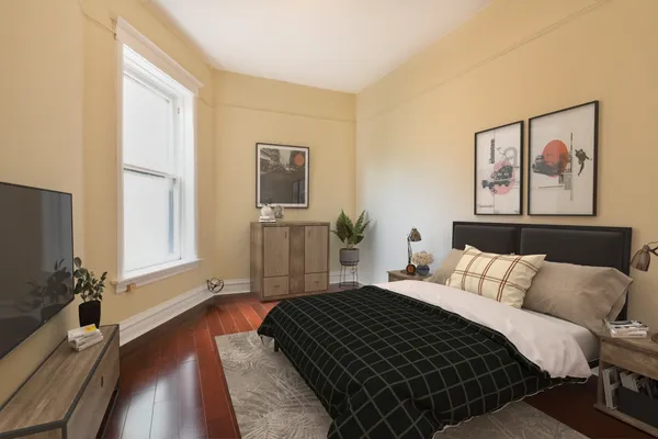 a bedroom with a bed and a flat screen tv