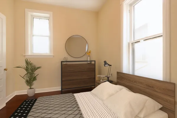 a bedroom with a bed and a potted plant