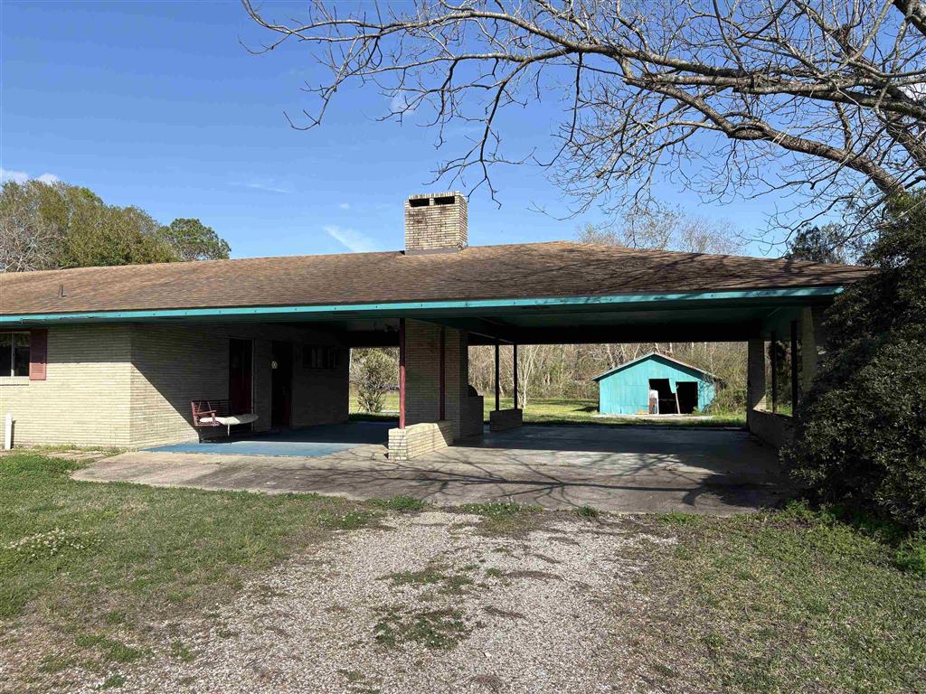 820 East South Street Welsh, LA 70591 - Photo 5 of 38 Barbecue pit located between oversized carport parking