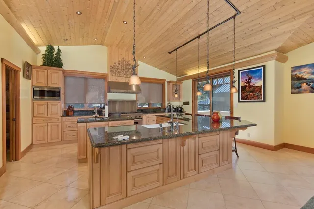 a kitchen with stainless steel appliances granite countertop a sink and cabinets