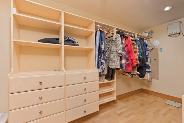 a view of walk in closet with clothes
