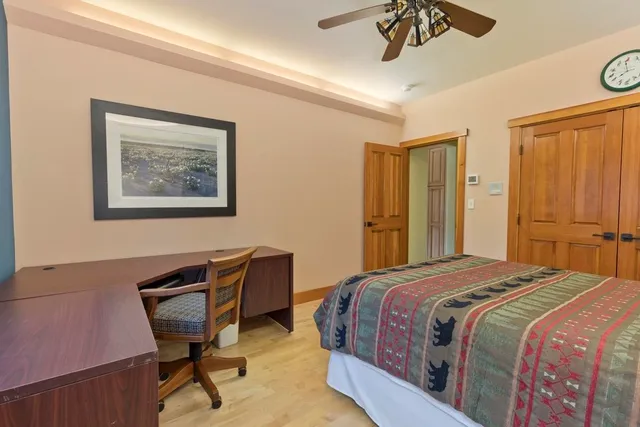 a bedroom with a bed and a chandelier